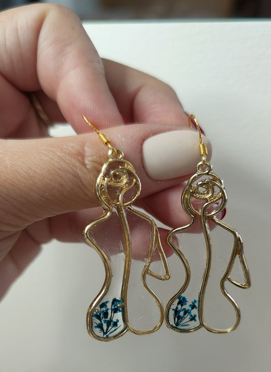 Female silhouette earrings with blue flowers